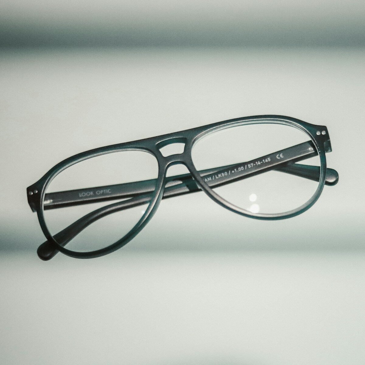 a pair of glasses sitting on top of a table