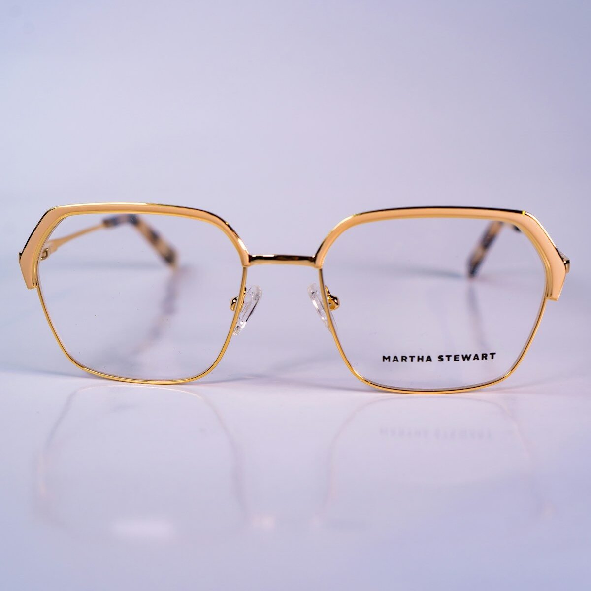 a pair of glasses sitting on top of a white table